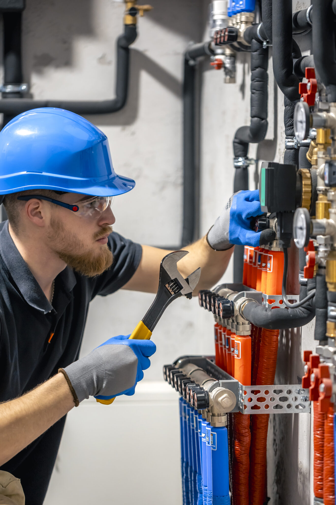 the technician checking the heating system in the boiler room.